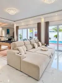 4 Bedroom House for Sale & Rent in East Pattaya outdoor pool deck with lounge chairs and umbrella