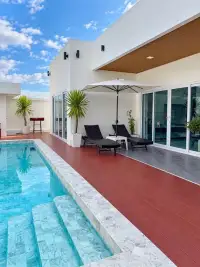 4 Bedroom House for Sale & Rent in East Pattaya game room with pool table, sofa and TV overlooking pool