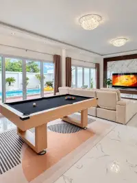4 Bedroom House for Sale & Rent in East Pattaya bedroom with wooden bed frame and gray shaggy rug