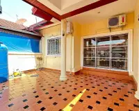 2 Bedroom House for Rent in East Pattaya covered side patio with tiled floor and water tank