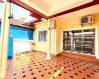 2 Bedroom House for Rent in East Pattaya covered patio area with sliding glass doors and water tank