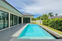 3 Bedroom House for Sale in East Pattaya infinity-edge pool alongside landscaped garden and hedges