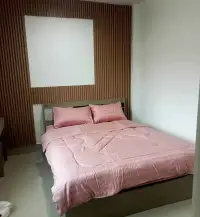 3 Bedroom House for Rent in East Pattaya bedroom with pink striped bedding and wood slat headboard wall