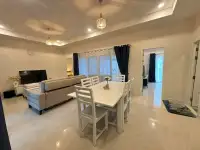 3 Bedroom House for Rent in East Pattaya open-plan dining area with white table and living room