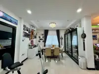 3 Bedroom House for Sale in East Pattaya open living and dining space with home gym equipment