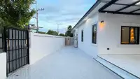 3 Bedroom House for Sale in East Pattaya side walkway with gated entrance and outdoor utility area