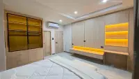 3 Bedroom House for Sale in East Pattaya bedroom with wooden built-in wardrobe and amber LED lighting
