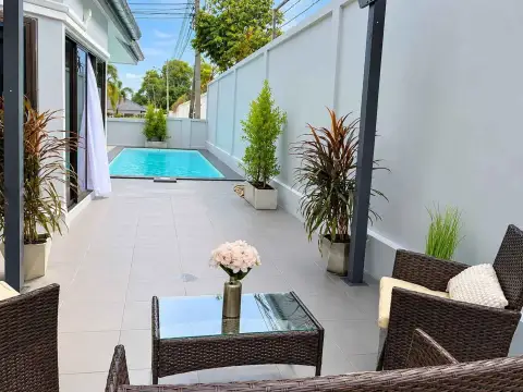 3 Bedroom House for Rent in East Pattaya poolside patio with rattan lounge seating and potted plants