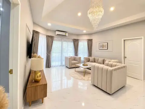 3 Bedroom House for Rent in East Pattaya spacious living room with crystal chandelier and sheer curtains
