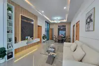 3 Bedroom House for Sale in East Pattaya spacious living and dining area with beige sofa and chandelier