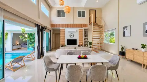 3 Bedroom House for Rent in East Pattaya open-plan living and dining area with spiral staircase and pool view