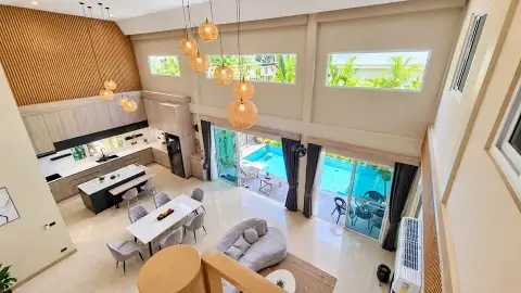 3 Bedroom House for Rent in East Pattaya upper floor view of kitchen, dining area and pool through glass doors