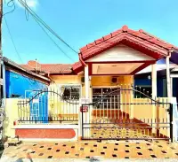2 Bedroom Townhouse for Rent in East Pattaya exterior view with red tiled roof, gated entrance, and tiled driveway