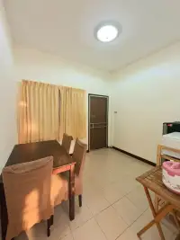 2 Bedroom Townhouse for Rent in East Pattaya dining area with wooden table, cushioned chairs, and tiled flooring