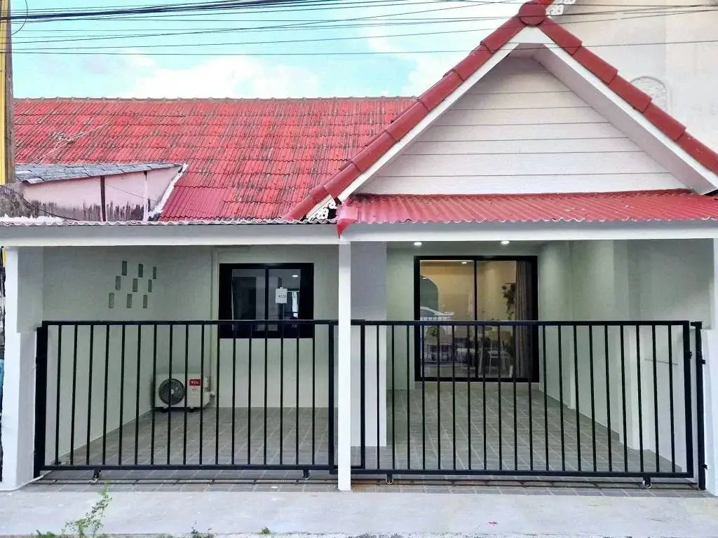 2 Bedroom Townhouse for Sale in East Pattaya exterior view with red tiled roof and black gate