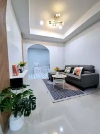 2 Bedroom Townhouse for Sale in East Pattaya living room with gray sofa and archway to kitchen