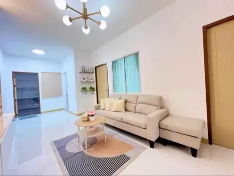2 Bedroom Townhouse for Sale in East Pattaya open living area with sofa, rug, and hallway view