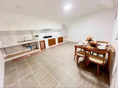 2 Bedroom Townhouse for Sale in East Pattaya kitchen and dining area with wooden table and subway tile backsplash