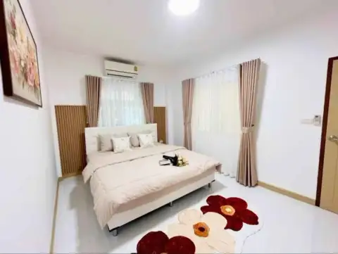 2 Bedroom Townhouse for Sale in East Pattaya bedroom with king-size bed and curtained windows