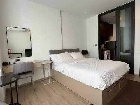 1 Bedroom Condo for Rent at EDGE Central Pattaya bedroom with desk, mirror, and kitchenette view