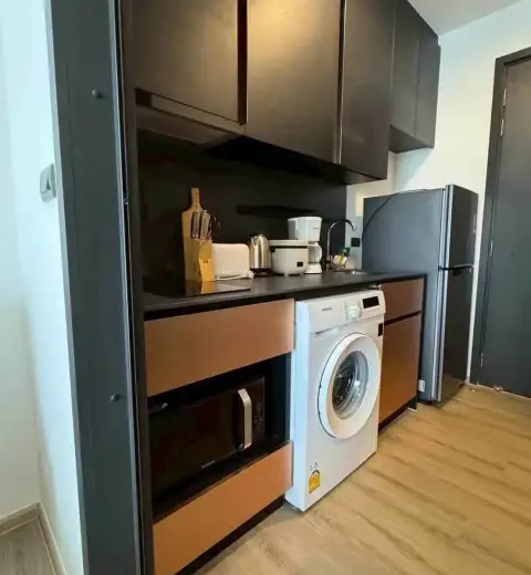 1 Bedroom Condo for Rent at EDGE Central Pattaya kitchenette with washing machine, fridge, and microwave
