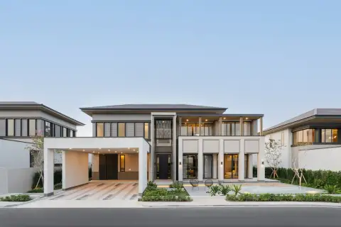 4 Bedroom House for Sale at Cascade two-storey modern exterior with covered carport, front pool, and landscaped garden at dusk