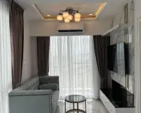 1 Bedroom Condo for Rent at The Empire Tower Pattaya living area with gray tufted sofa, TV console and marble accent wall