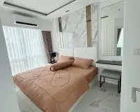 1 Bedroom Condo for Rent at The Empire Tower Pattaya bedroom with marble headboard wall, dressing table and mirror