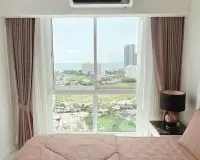 1 Bedroom Condo for Rent at The Empire Tower Pattaya bedroom window view overlooking cityscape and sea in the distance