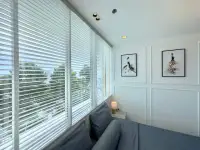 1 Bedroom Condo for Sale at The Empire Tower Pattaya seating nook with blinds, garden view, and fashion artwork