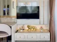 1 Bedroom Condo for Sale at The Empire Tower Pattaya TV console with gold lion statue and floral decor