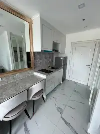 Studio Condo for Sale at The Empire Tower Pattaya compact kitchen with mirrored vanity and mosaic backsplash