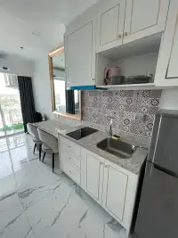 Studio Condo for Sale at The Empire Tower Pattaya kitchenette with marble countertop, sink and refrigerator
