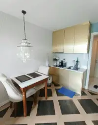 1 Bedroom Condo for Sale at Espana Condo Resort kitchenette with gold cabinets and dining table