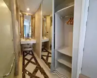 1 Bedroom Condo for Sale at Espana Condo Resort bathroom vanity with mirrors and closet with hangers