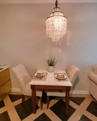 1 Bedroom Condo for Sale at Espana Condo Resort dining nook with chandelier and two-seat table setting