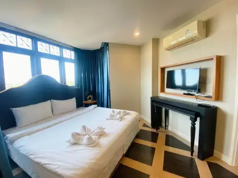 2 Bedroom Condo for Rent at Espana Condo Resort bedroom with wall-mounted TV and towel decor on bed
