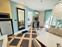 1 Bedroom Condo for Sale at Espana Condo Resort open living area with geometric tile floor, mirror, and balcony access