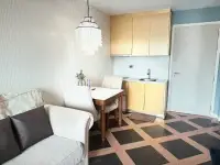 1 Bedroom Condo for Sale at Espana Condo Resort kitchenette with yellow cabinets, dining table, and sofa