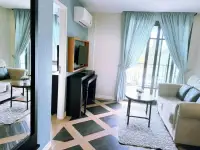 1 Bedroom Condo for Sale at Espana Condo Resort living room with TV console, sofas, and balcony doors