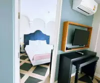 1 Bedroom Condo for Sale at Espana Condo Resort hallway view into bedroom with wall-mounted TV and desk