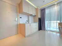 1 Bedroom Condo for Sale at Estanan Condo compact kitchenette with wood cabinetry and sink near entrance