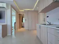 1 Bedroom Condo for Sale at Estanan Condo galley kitchen with countertop, sink, and built-in storage units