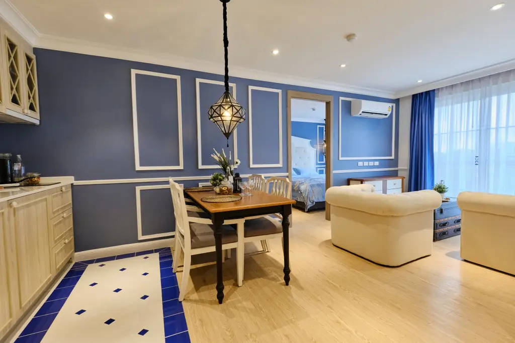 2 Bedroom Condo for Sale at Seven Seas Cote d'Azur: dining area with blue wall, pendant light, and partial view of bedroom.