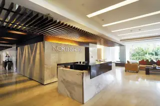 Northshore Pattaya modern fitness center with various weight training machines, benches, and mirrors.