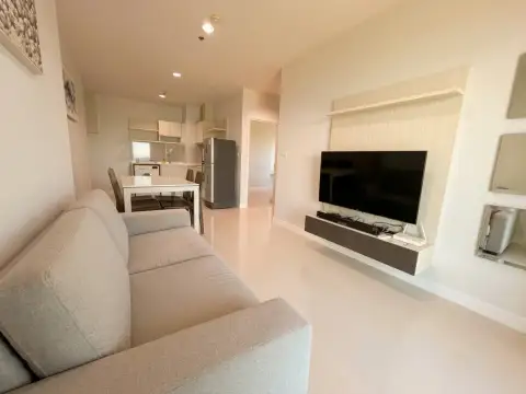2 Bedroom Condo for Sale at Centric Sea open-plan living area with dining table and kitchenette