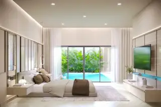 Villa Trivana striking modern house exterior with curved walls, illuminated facade, and multiple luxury cars.