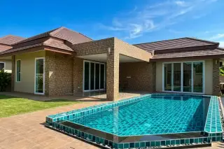 Amaliya Village private swimming pool and modern house exterior with covered patio and sliding glass doors.