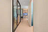 2 Bedroom Condo for Sale at Once Wong Amat hallway entrance with glass partition, wood flooring, and built-in TV shelving unit
