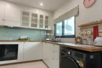 4 Bedroom House for Rent at Supalai Palm Ville Sukhumvit - Rongpo - kitchen with white cabinets, wood countertops, and a washing machine.